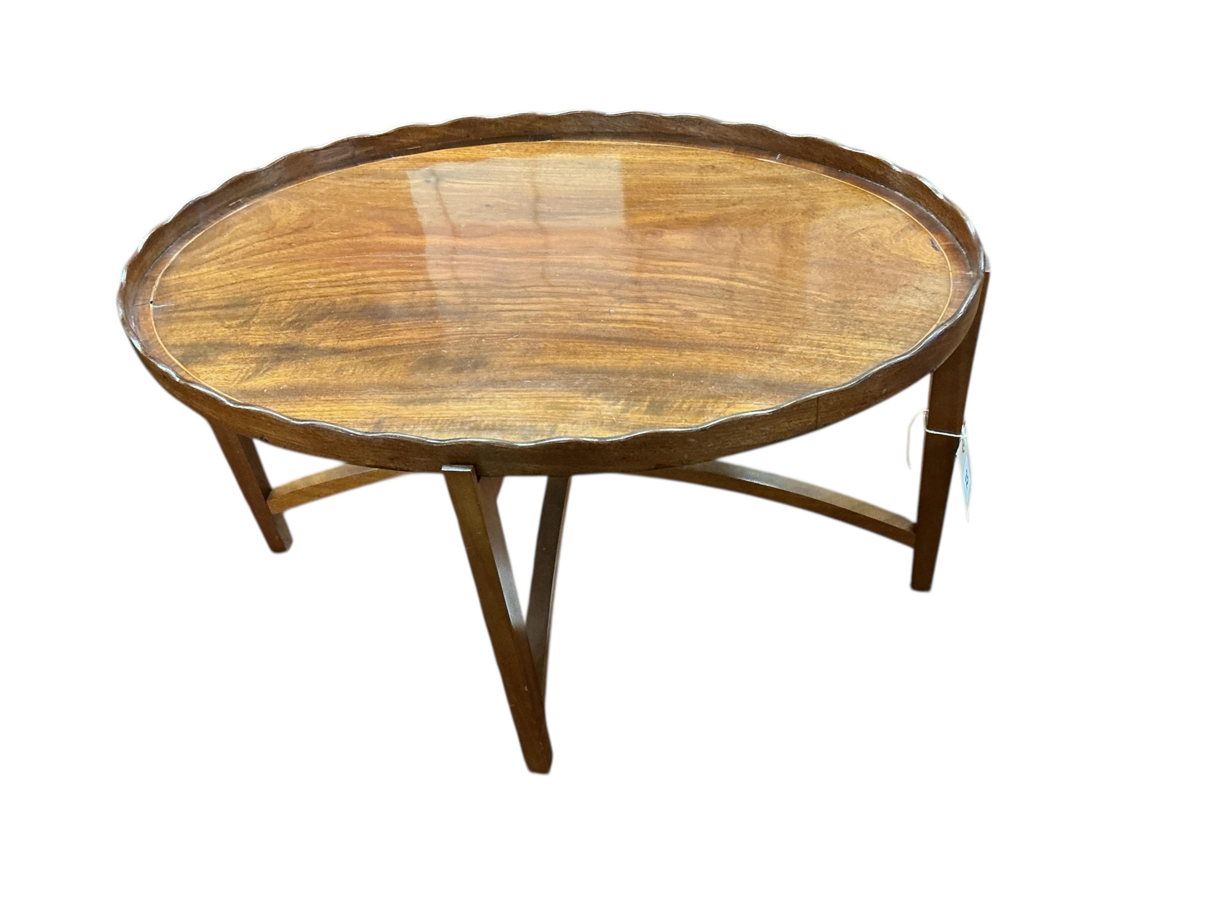 A George III oval mahogany tea tray on later stand, width 58cm, depth 39cm, height 33cm